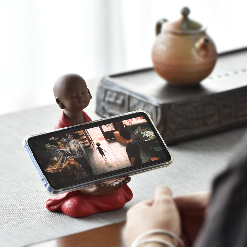 Little monk with a phone stand